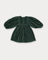 Early Sunday, Belle Dress in Forest Green, made from Cotton Velvet Velour's fabric, featuring a flowing silhouette with puff sleeves and gentle gathers, shown in a back flat-lay view