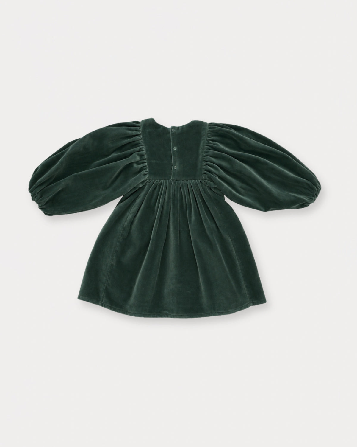 Early Sunday, Belle Dress in Forest Green, made from Cotton Velvet Velour's fabric, featuring a flowing silhouette with puff sleeves and gentle gathers, shown in a back flat-lay view