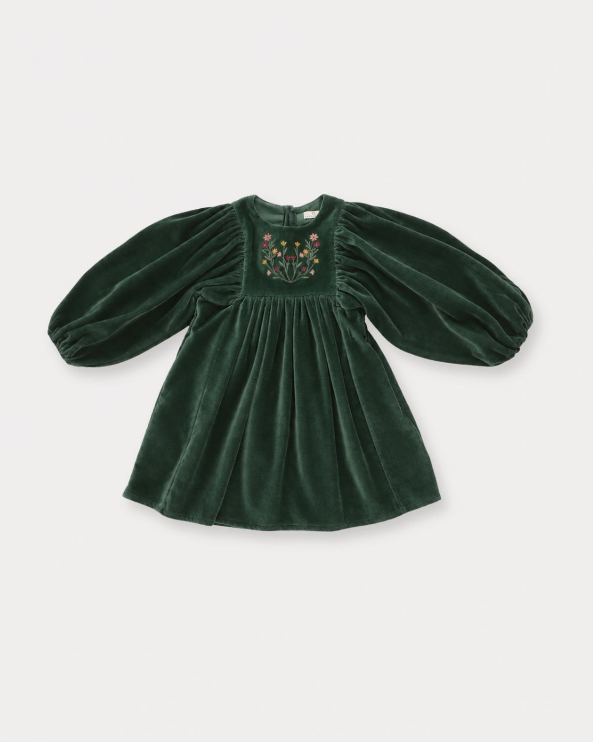 Early Sunday, Belle Dress in Forest Green, made from Cotton Velvet Velour's fabric, featuring a flowing silhouette with puff sleeves and gentle gathers, shown in a front flat-lay view
