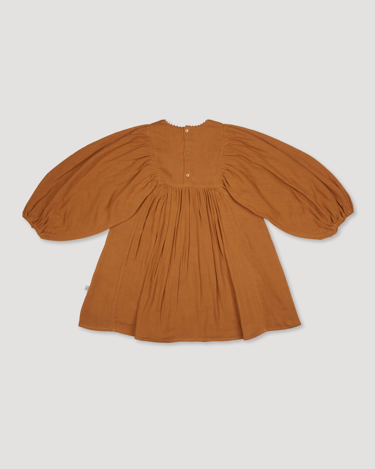 Early Sunday, Belle Dress in Almond, made from Dyed Cotton Double Gauze fabric, featuring Hand-embroidered floral bodice with voluminous puff sleeves for a soft, enchanting silhouette, shown in a back flat-lay view