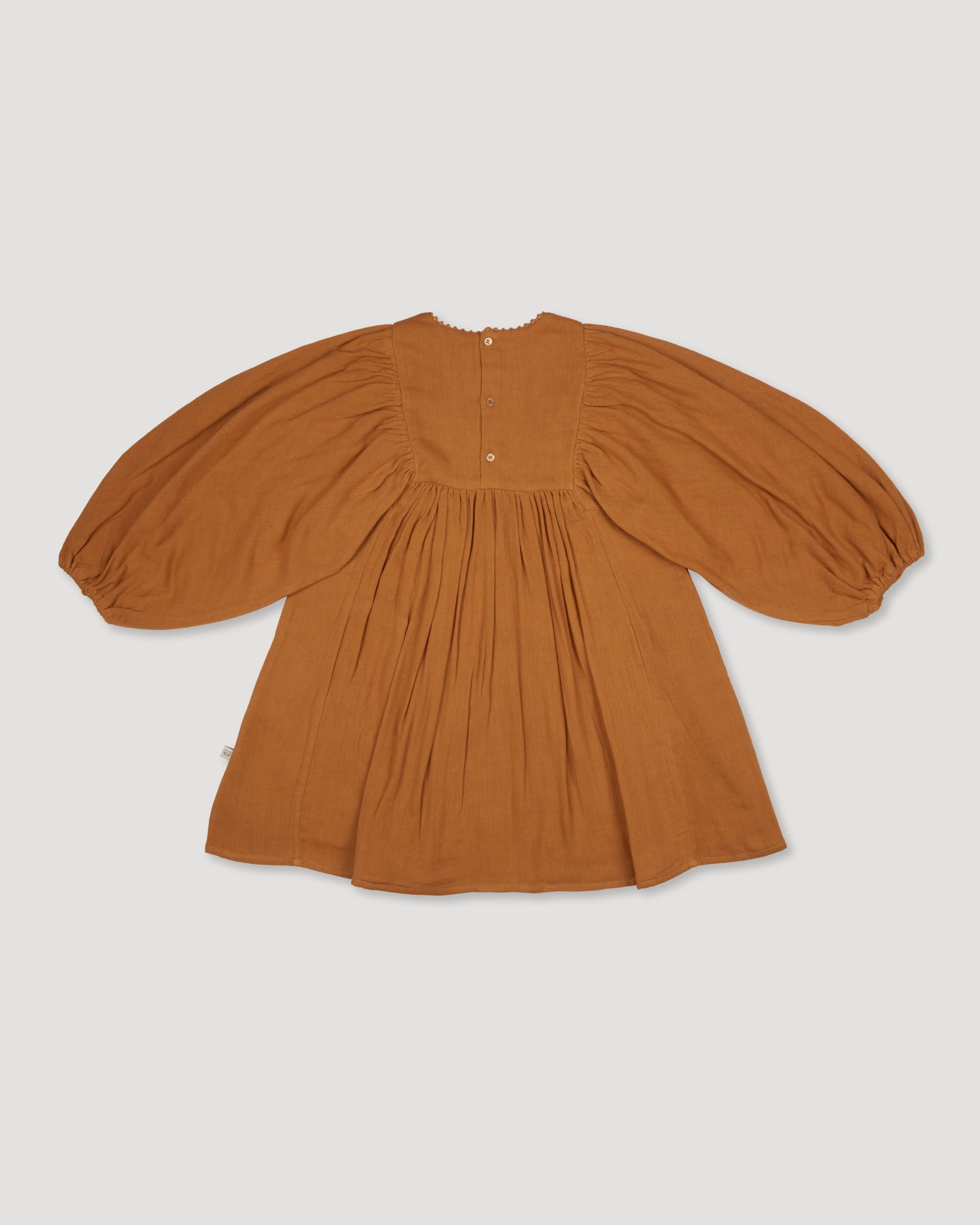 Early Sunday, Belle Dress in Almond, made from Dyed Cotton Double Gauze fabric, featuring Hand-embroidered floral bodice with voluminous puff sleeves for a soft, enchanting silhouette, shown in a back flat-lay view