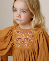 Early Sunday, Belle Dress in Almond, made from Dyed Cotton Double Gauze fabric, featuring Hand-embroidered floral bodice with voluminous puff sleeves for a soft, enchanting silhouette, shown in a close-up of print