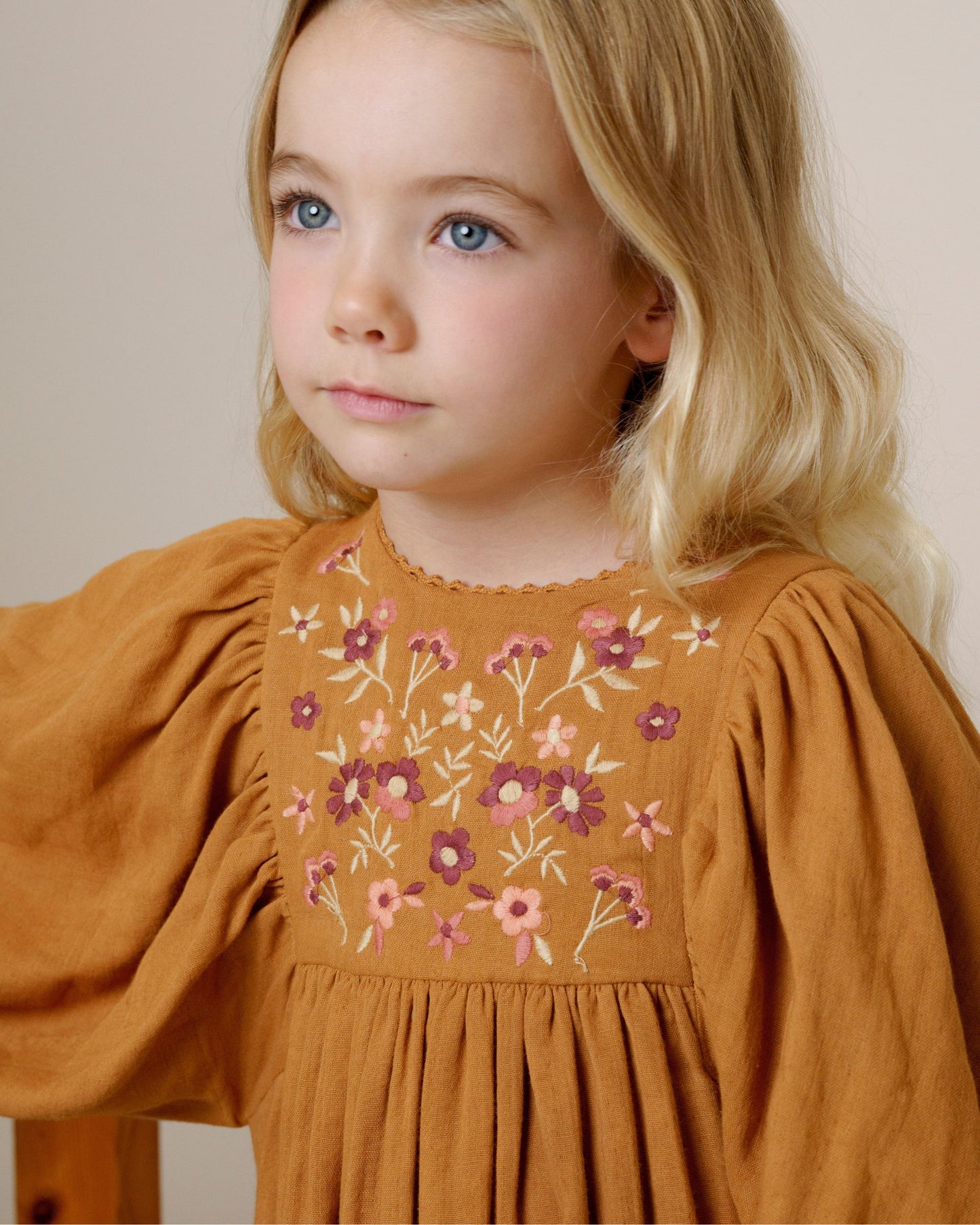Early Sunday, Belle Dress in Almond, made from Dyed Cotton Double Gauze fabric, featuring Hand-embroidered floral bodice with voluminous puff sleeves for a soft, enchanting silhouette, shown in a close-up of print
