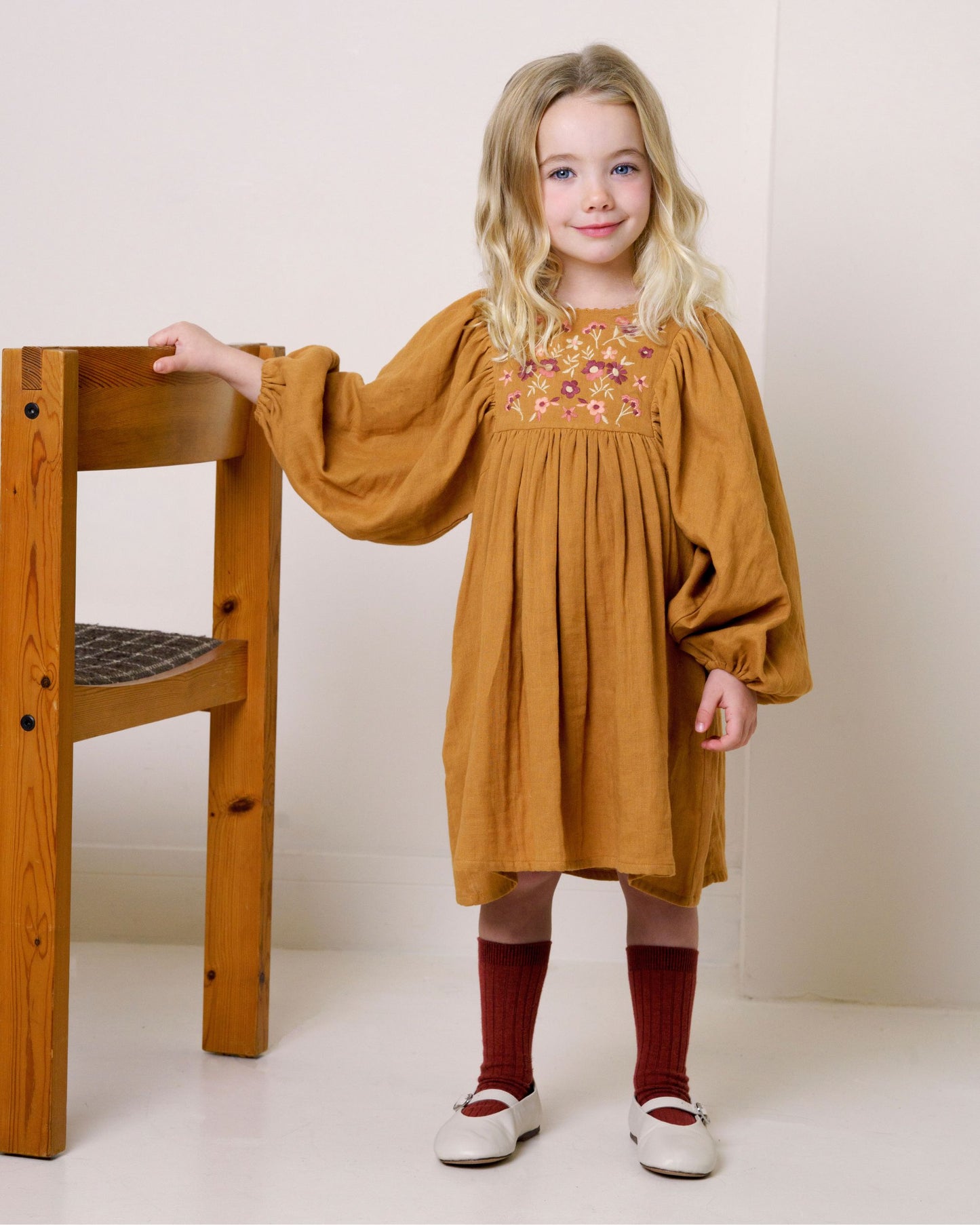 Early Sunday, Belle Dress in Almond, made from Dyed Cotton Double Gauze fabric, featuring Hand-embroidered floral bodice with voluminous puff sleeves for a soft, enchanting silhouette, shown in a front view of model wearing it