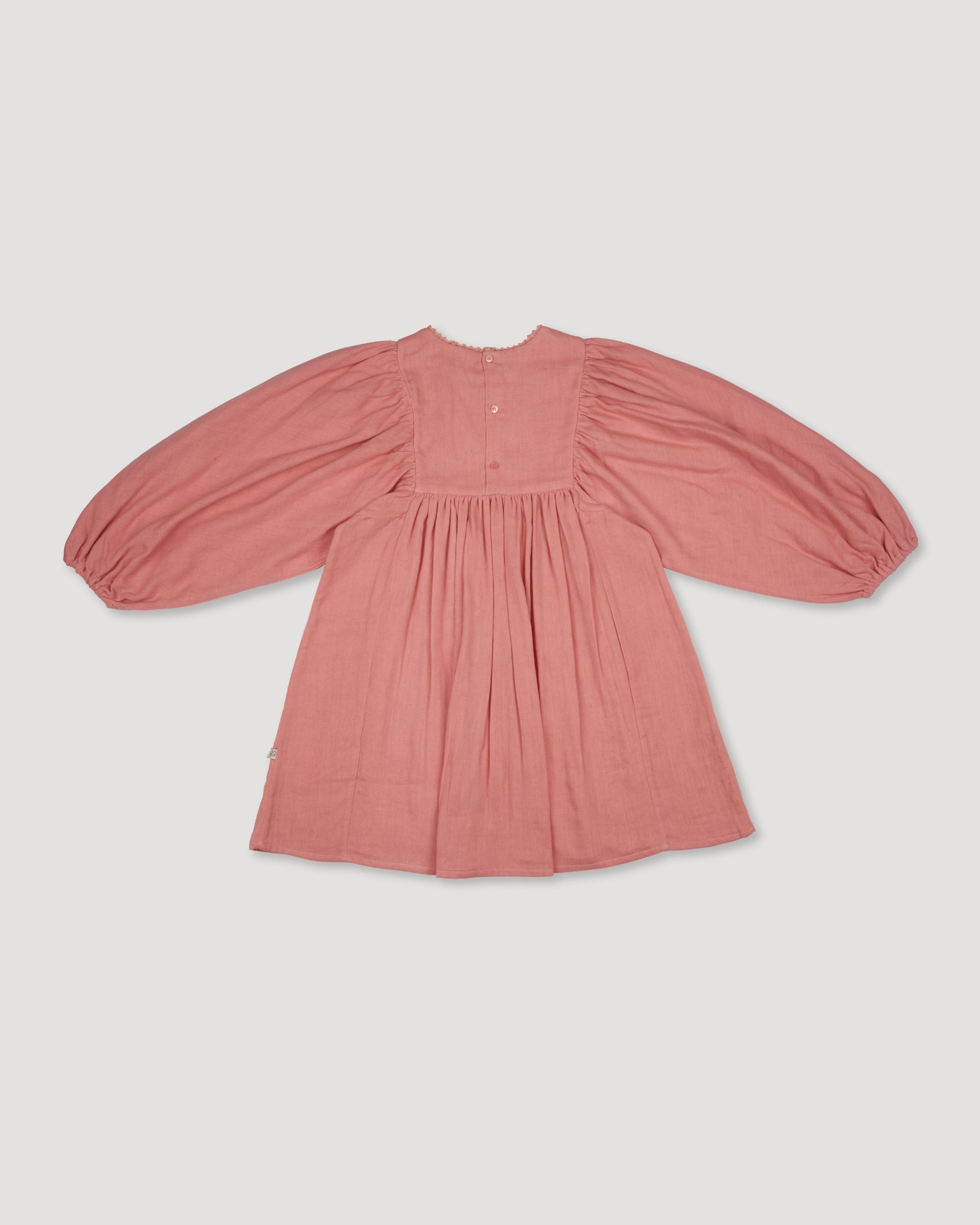 Early Sunday, Belle Dress in Rose, made from Dyed Cotton Double Gauze fabric, featuring Hand-embroidered floral bodice with voluminous puff sleeves for a soft, enchanting silhouette, shown in a back flat-lay view