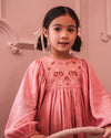 Early Sunday, Belle Dress in Rose, made from Dyed Cotton Double Gauze fabric, featuring Hand-embroidered floral bodice with voluminous puff sleeves for a soft, enchanting silhouette, shown in a close-up of print