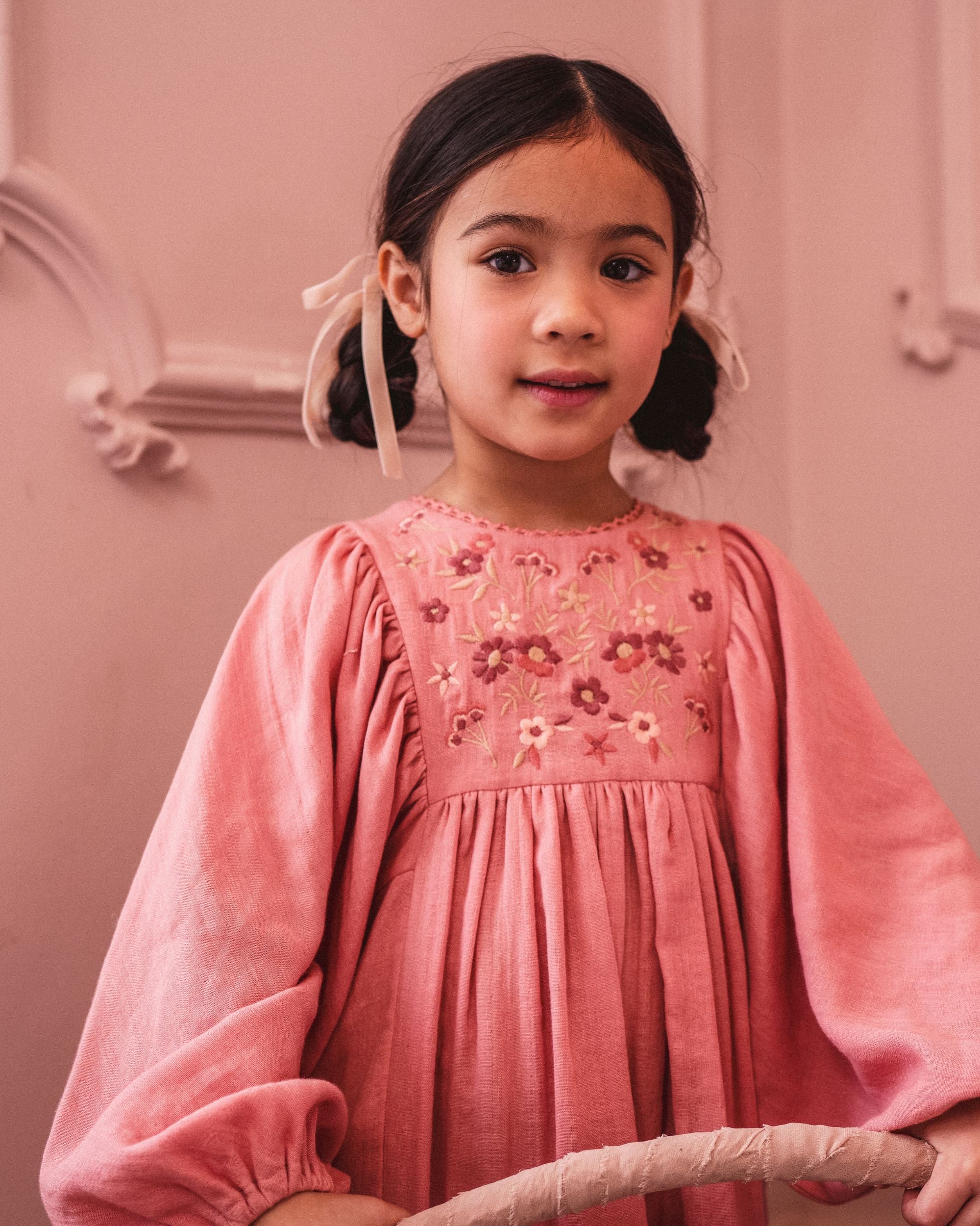 Early Sunday, Belle Dress in Rose, made from Dyed Cotton Double Gauze fabric, featuring Hand-embroidered floral bodice with voluminous puff sleeves for a soft, enchanting silhouette, shown in a close-up of print