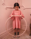 Early Sunday, Belle Dress in Rose, made from Dyed Cotton Double Gauze fabric, featuring Hand-embroidered floral bodice with voluminous puff sleeves for a soft, enchanting silhouette, shown in a front view of model wearing it
