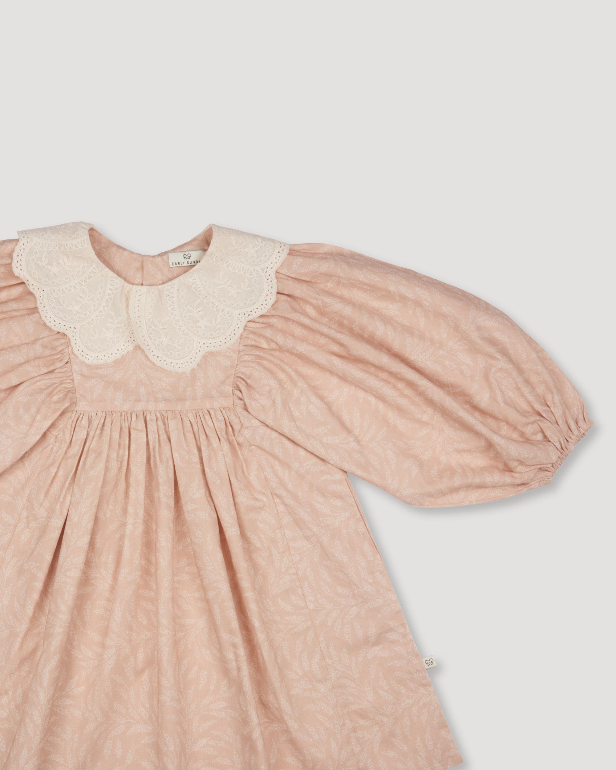 Early Sunday, Belle Dress in Feather print, made from Printed Cotton Cambric fabric, featuring Hand-embroidered floral bodice with voluminous puff sleeves for a soft, enchanting silhouette, shown in a closeup flat-lay view