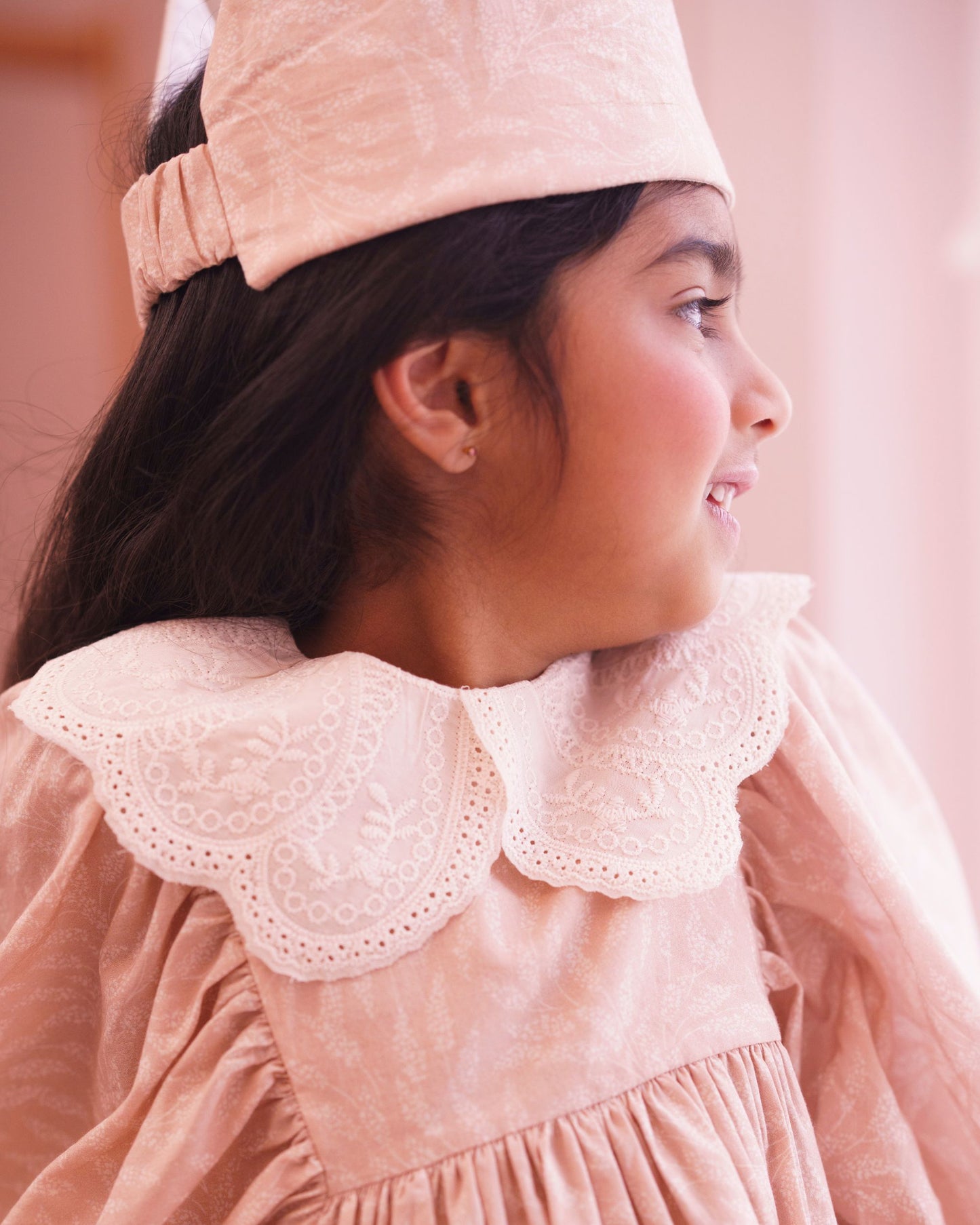 Early Sunday, Belle Dress in Feather print, made from Printed Cotton Cambric fabric, featuring Hand-embroidered floral bodice with voluminous puff sleeves for a soft, enchanting silhouette, shown in a close up shot of model wearing it