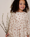 Early Sunday, Belle Dress in Ditsy Bouquet Cream print, made from Printed Viscose Rayon Twill fabric, featuring Hand-embroidered floral bodice with voluminous puff sleeves for a soft, enchanting silhouette, shown in a close up shot of model wearing it