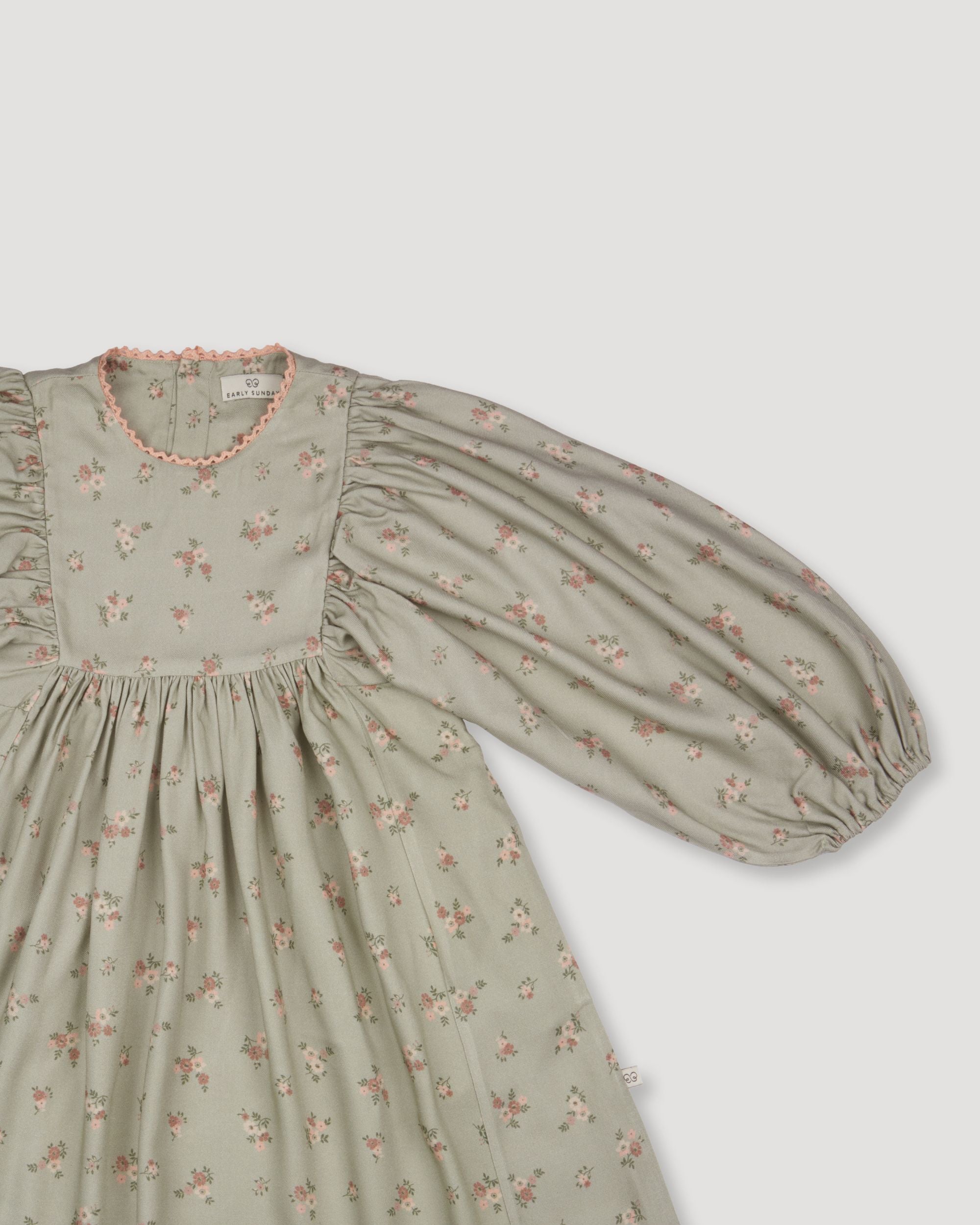 Early Sunday, Belle Dress in Ditsy Bouquet Jade print, made from Printed Viscose Rayon Twill fabric, featuring Hand-embroidered floral bodice with voluminous puff sleeves for a soft, enchanting silhouette, shown in a closeup flat-lay view