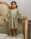 Early Sunday, Belle Dress in Ditsy Bouquet Jade print, made from Printed Viscose Rayon Twill fabric, featuring Hand-embroidered floral bodice with voluminous puff sleeves for a soft, enchanting silhouette, shown in a front view of model wearing it