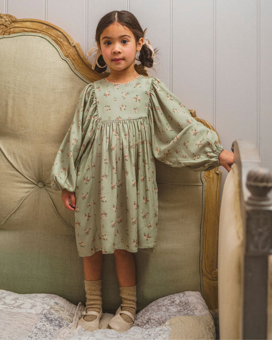 Early Sunday, Belle Dress in Ditsy Bouquet Jade print, made from Printed Viscose Rayon Twill fabric, featuring Hand-embroidered floral bodice with voluminous puff sleeves for a soft, enchanting silhouette, shown in a front view of model wearing it