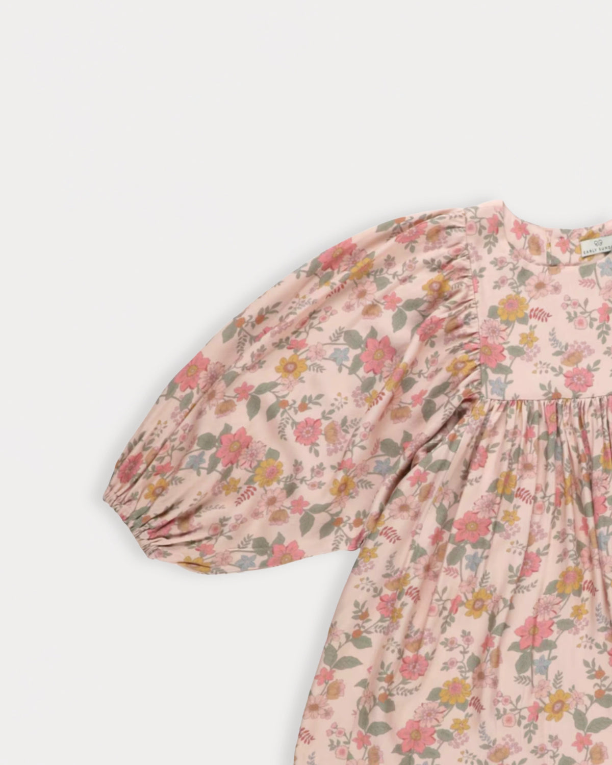 Early Sunday, Belle Dress in Bloom, made from Printed Viscose Twill fabric, featuring a square yoke bodice with puff sleeves and delicate gathered detailing, shown in a closeup flat-lay view