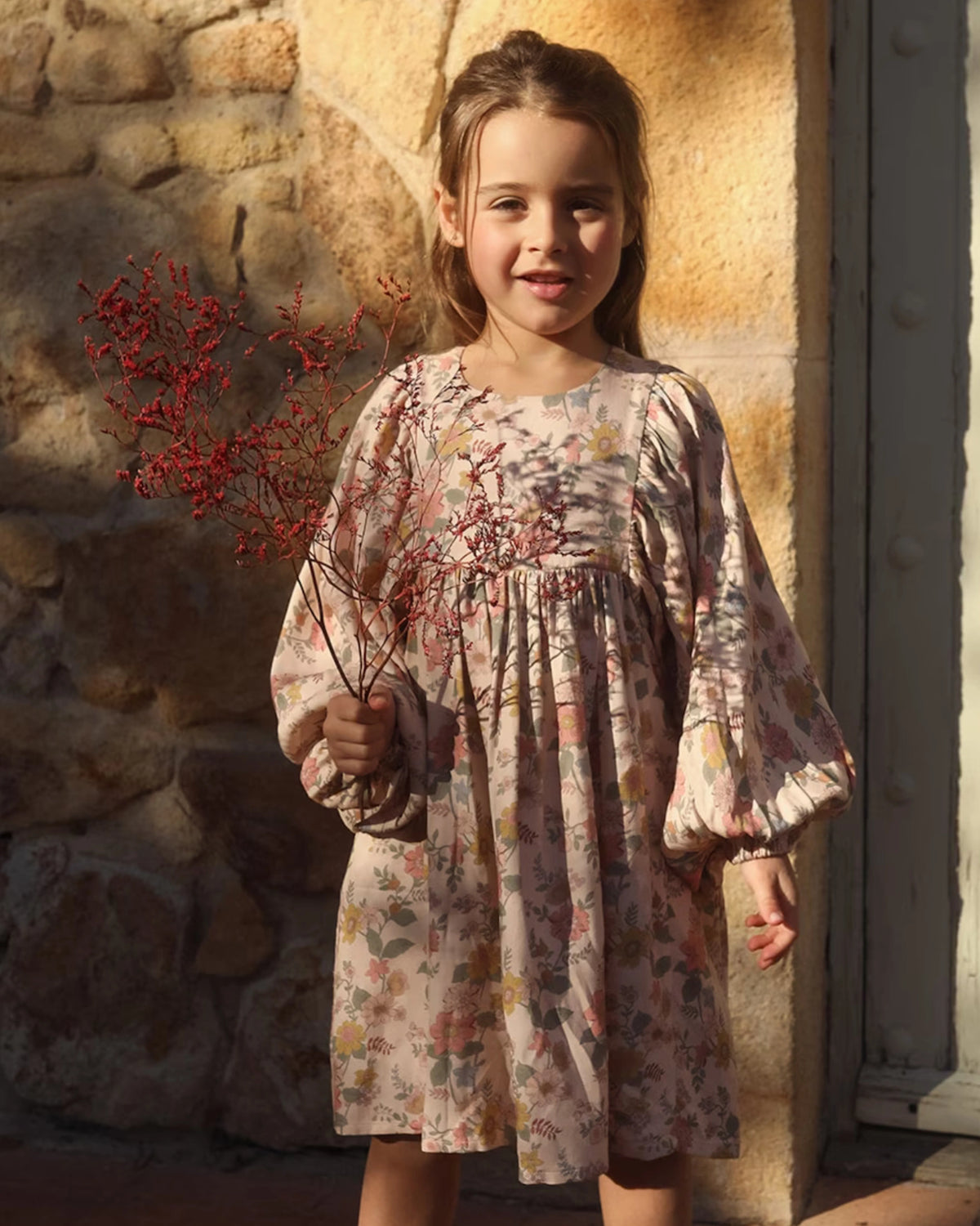 Early Sunday, Belle Dress in Bloom, made from Printed Viscose Twill fabric, featuring a square yoke bodice with puff sleeves and delicate gathered detailing, shown in a front view of model wearing outdoors
