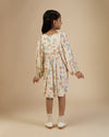Early Sunday, Belle Dress in Falling Leaves Beige print, made from Printed Viscose Twill fabric, featuring a-line silhouette, bishop sleeves, back button closure, and mid-length, shown in a back view of model wearing it
