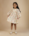 Early Sunday, Belle Dress in Falling Leaves Beige print, made from Printed Viscose Twill fabric, featuring a-line silhouette, bishop sleeves, back button closure, and mid-length, shown in a front view of model wearing it