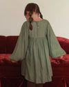 Early Sunday, Belle Dress in Sage Green, made from Viscose Twill fabric, featuring a square yoke bodice with puff sleeves and delicate gathered detailing, shown in a back view of model wearing it