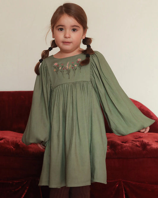 Early Sunday, Belle Dress in Sage Green, made from Viscose Twill fabric, featuring a square yoke bodice with puff sleeves and delicate gathered detailing, shown in a front view of model wearing it