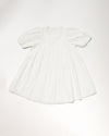 Early Sunday, Beth Dress in Ivory color, made from 100% cotton all over embroidered fabric, featuring Puff sleeves, contrast scalloped collar for a vintage touch, shown in a back flat-lay view.