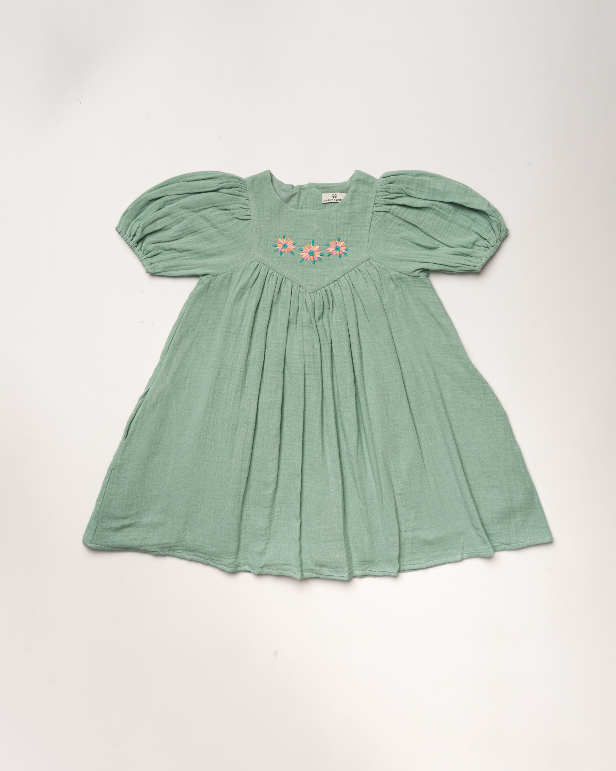 Early Sunday, Beth Dress in Mint color, made from 100% cotton double gauze solid fabric, featuring Puff sleeves, contrast scalloped collar for a vintage touch, shown in a front flat-lay view.