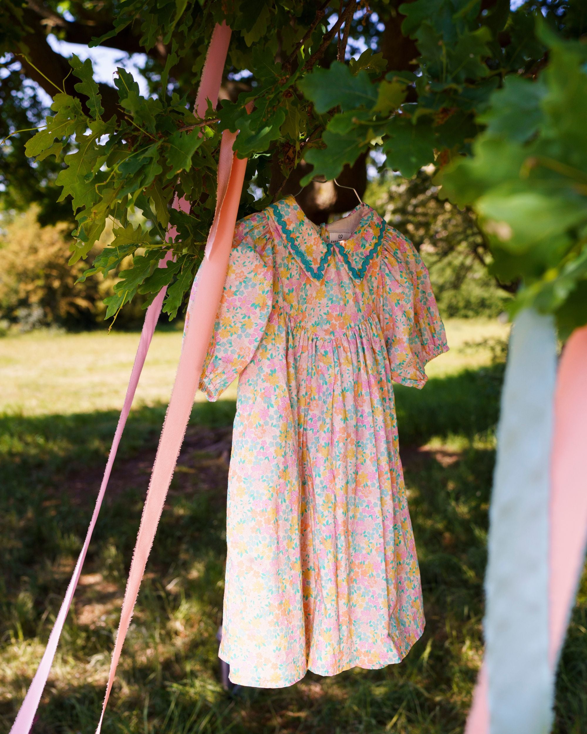 Early Sunday, Beth Dress in Emma Floral Mint color, made from printed cotton cambric fabric, featuring Puff sleeves, contrast scalloped collar for a vintage touch, shown in a close-up of print.
