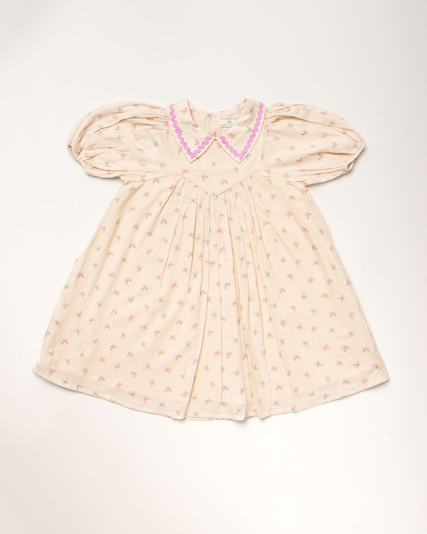 Early Sunday, Beth Dress in Butterfly Print color, made from printed cotton tiny swiss dobby fabric, featuring Puff sleeves, contrast scalloped collar for a vintage touch, shown in a front flat-lay view.