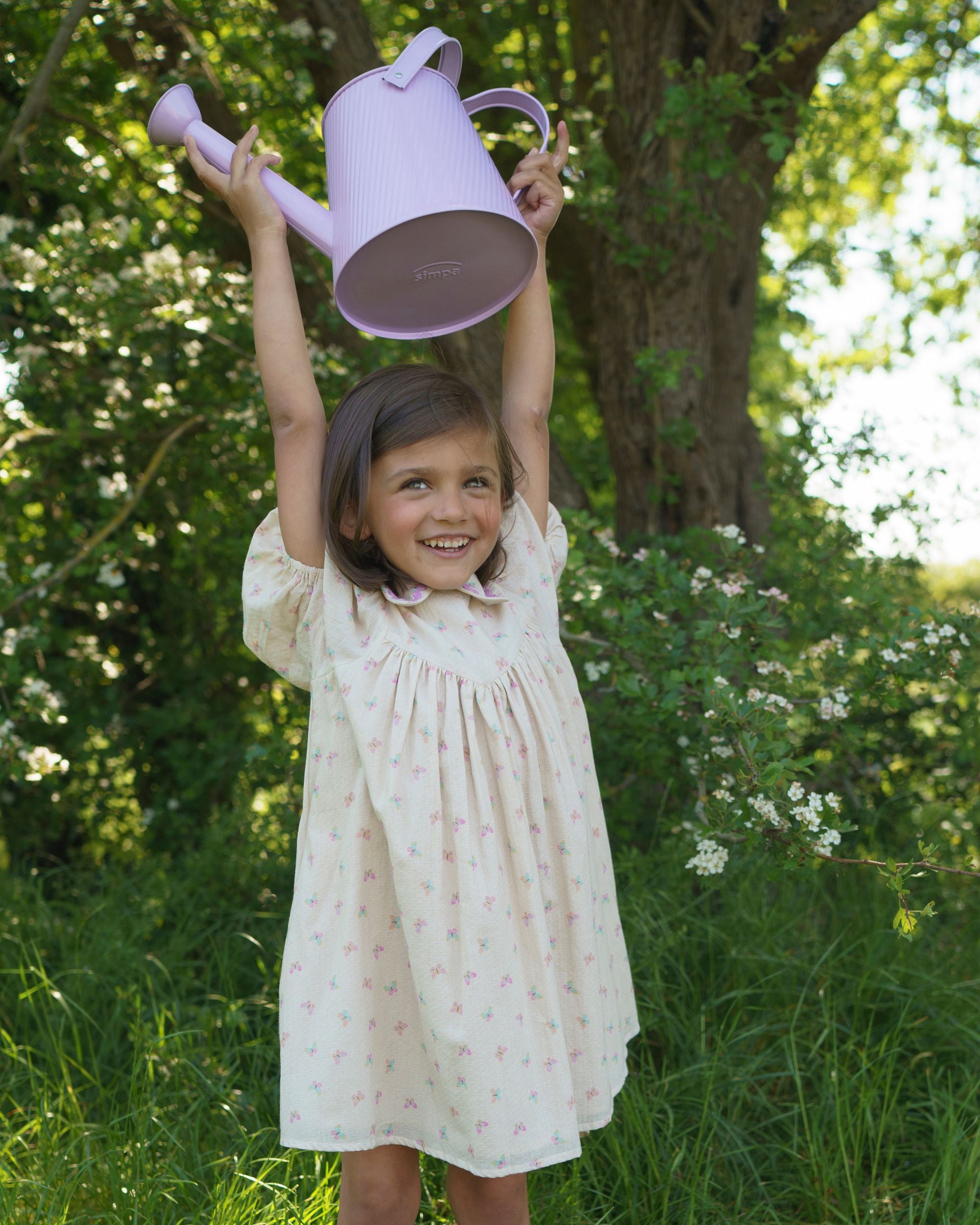 Early Sunday, Beth Dress in Butterfly Print color, made from printed cotton tiny swiss dobby fabric, featuring Puff sleeves, contrast scalloped collar for a vintage touch, shown in a front view of model wearing.