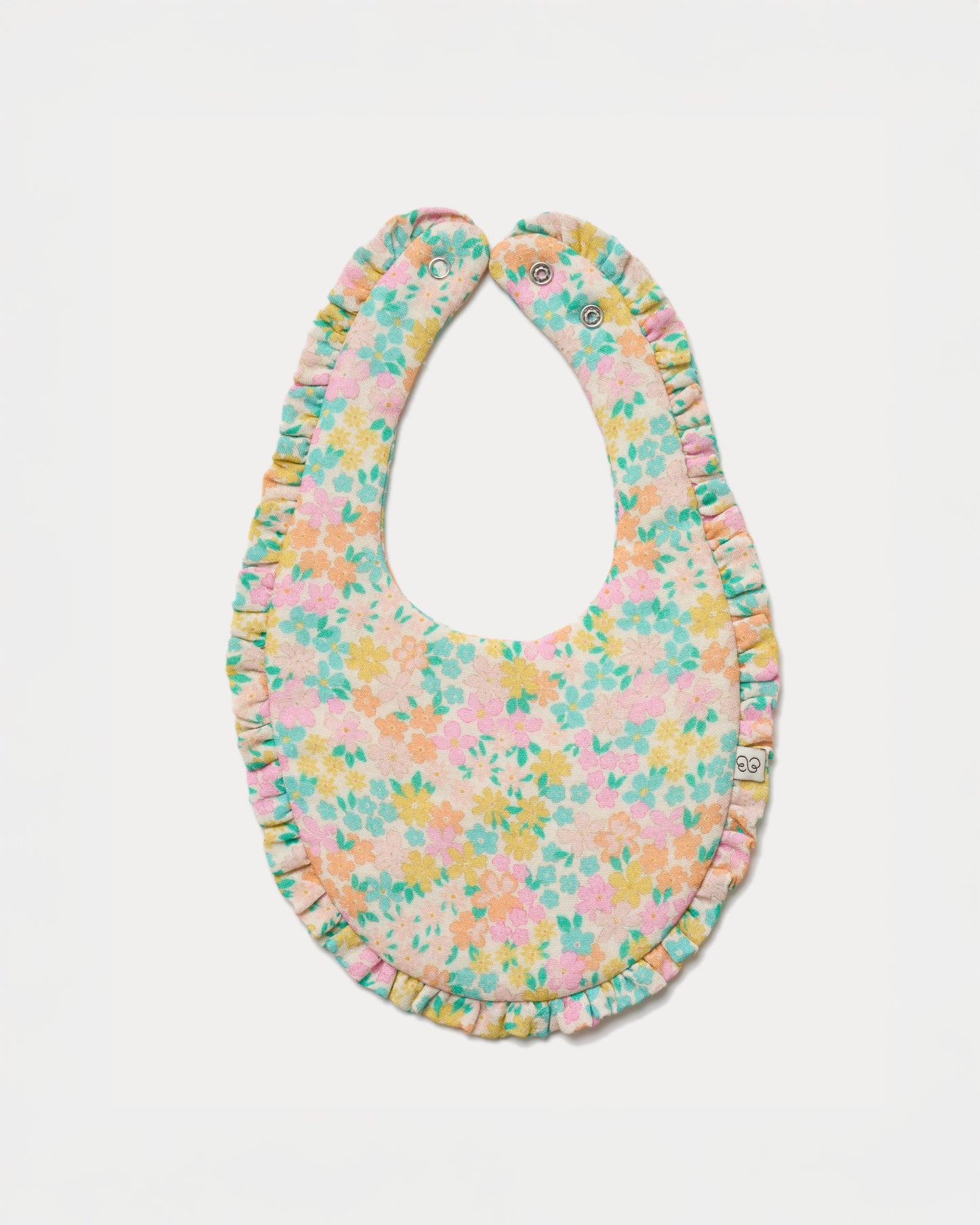 Early Sunday, Bib in Emma Floral Mint color, made from Organic Printed Cotton Double Gauze fabric, shown in a front flat-lay view