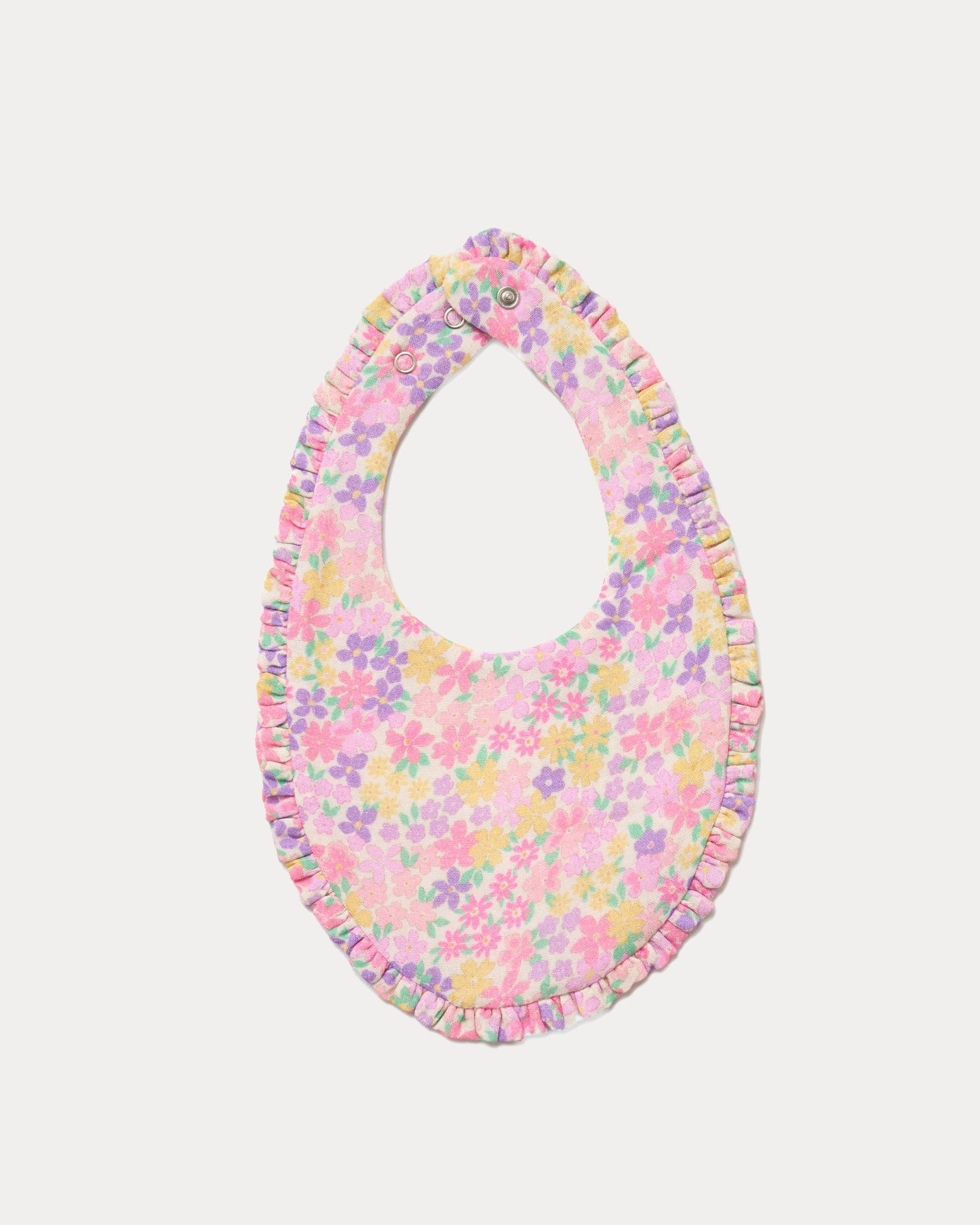 Early Sunday, Bib in Emma Floral Purple color, made from Organic Printed Cotton Double Gauze fabric, shown in a back flat-lay view