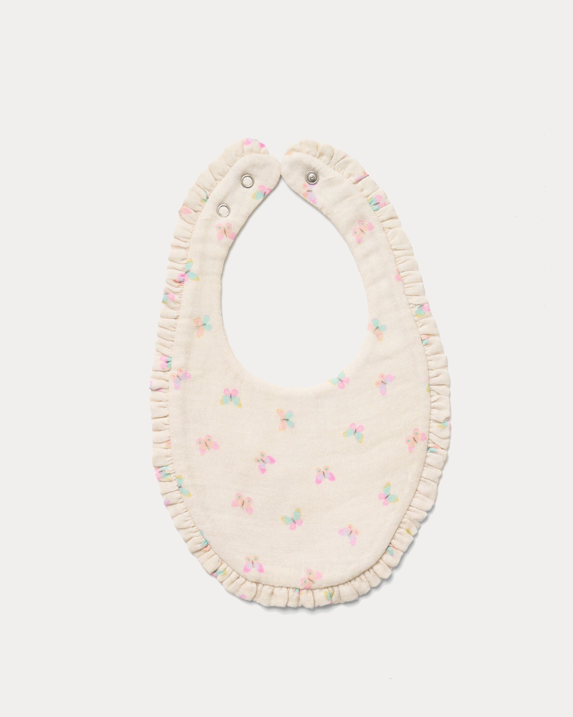 Early Sunday, Bib in Butterflies print, made from Printed Cotton Double Gauze fabric, shown in a back flat-lay view