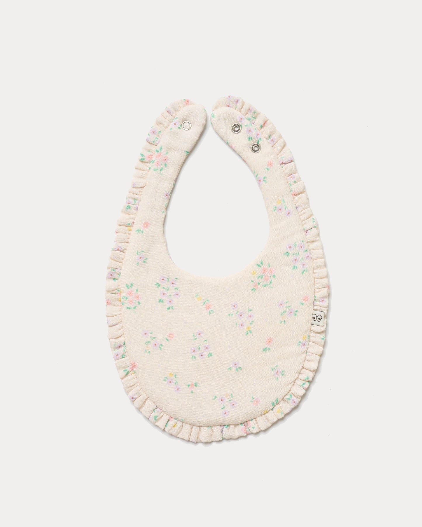 Early Sunday, Bib in Painted Bouquet print, made from Printed Cotton Double Gauze fabric, shown in a front flat-lay view