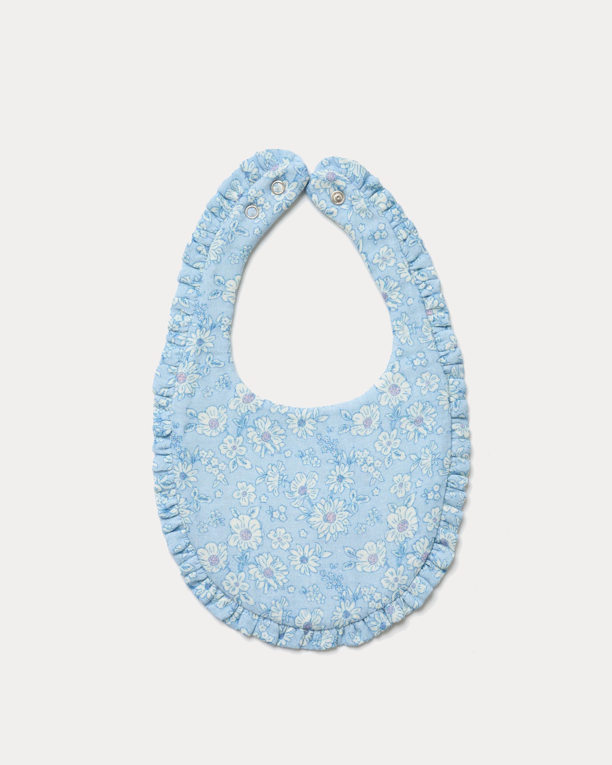 Early Sunday, Bib in Tonal Floral Blue color, made from Printed Cotton Double Gauze fabric, shown in a back flat-lay view