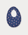Early Sunday, Bib in Ditsy Bouquet Navy Blue, made from Printed Cotton Satin fabric, featuring featuring a soft and comfortable design with an adjustable fit, shown in a back flat-lay view