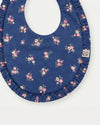 Early Sunday, Bib in Ditsy Bouquet Navy Blue, made from Printed Cotton Satin fabric, featuring featuring a soft and comfortable design with an adjustable fit, shown in a closeup flat-lay view