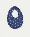 Early Sunday, Bib in Ditsy Bouquet Navy Blue, made from Printed Cotton Satin fabric, featuring a soft and comfortable design with an adjustable fit, shown in a front flat-lay view