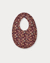 Early Sunday, Bib in Garden Flowers Plum, made from Printed Cotton Satin fabric, featuring featuring a soft and comfortable design with an adjustable fit, shown in a back flat-lay view