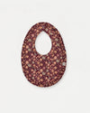 Early Sunday, Bib in Garden Flowers Plum, made from Printed Cotton Satin fabric, featuring featuring a soft and comfortable design with an adjustable fit, shown in a front flat-lay view