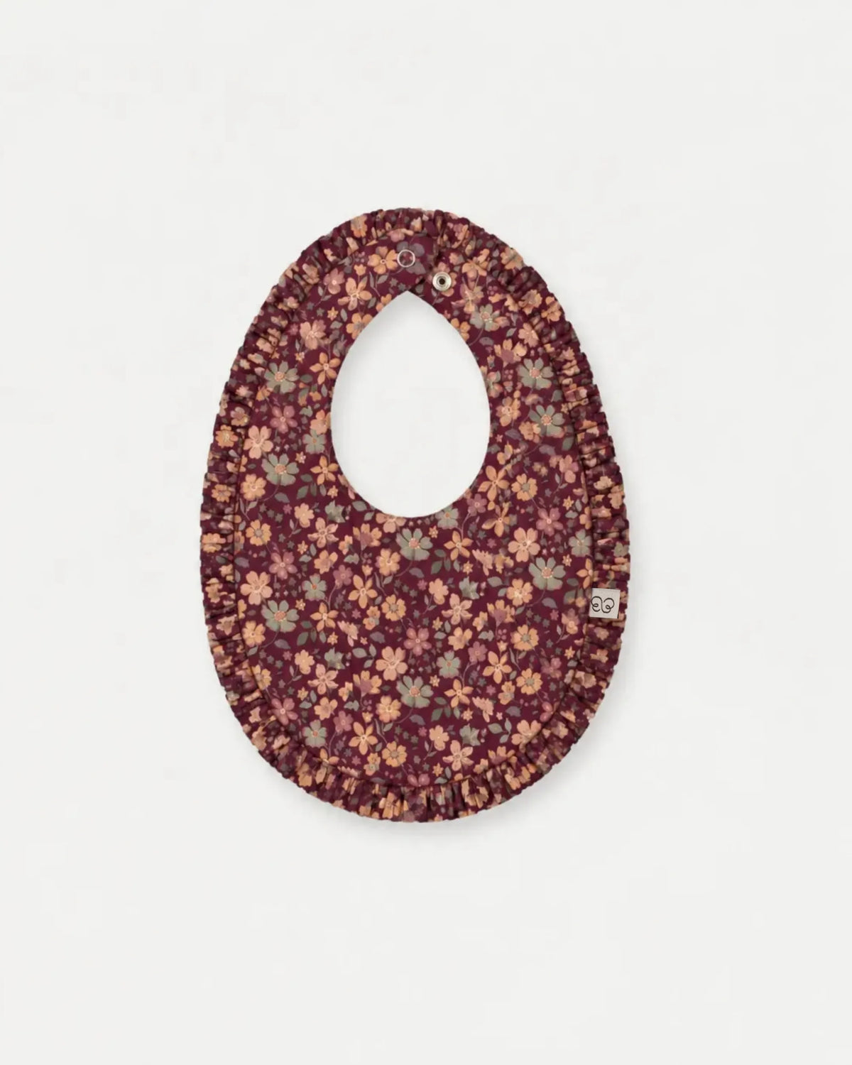 Early Sunday, Bib in Garden Flowers Plum, made from Printed Cotton Satin fabric, featuring featuring a soft and comfortable design with an adjustable fit, shown in a front flat-lay view