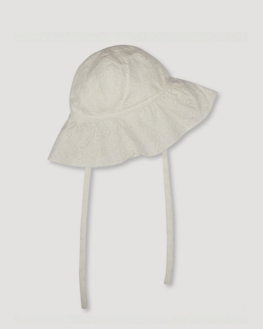 Early Sunday, Bonnie Baby Sun Hat in Ivory color, made from All-Over Eyelet Embroidered Cotton Schifflie fabric, featuring wide brim for sun protection, designed to be lightweight and comfortable for all-day wear, shown in a front flat-lay view