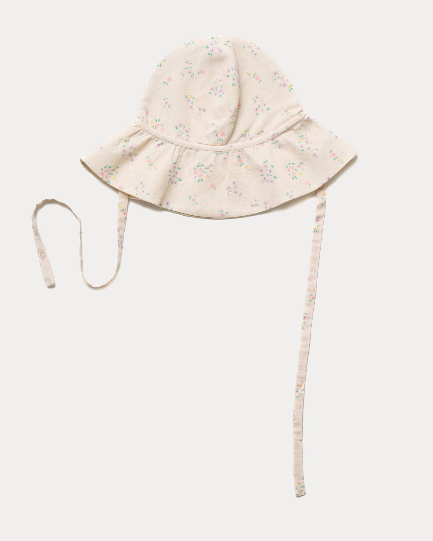 Early Sunday, Bonnie Hat Cap in Painted Bouquet print, made from 70% Cotton, 30% Linen fabric, shown in an angled view with wide brim and tie straps