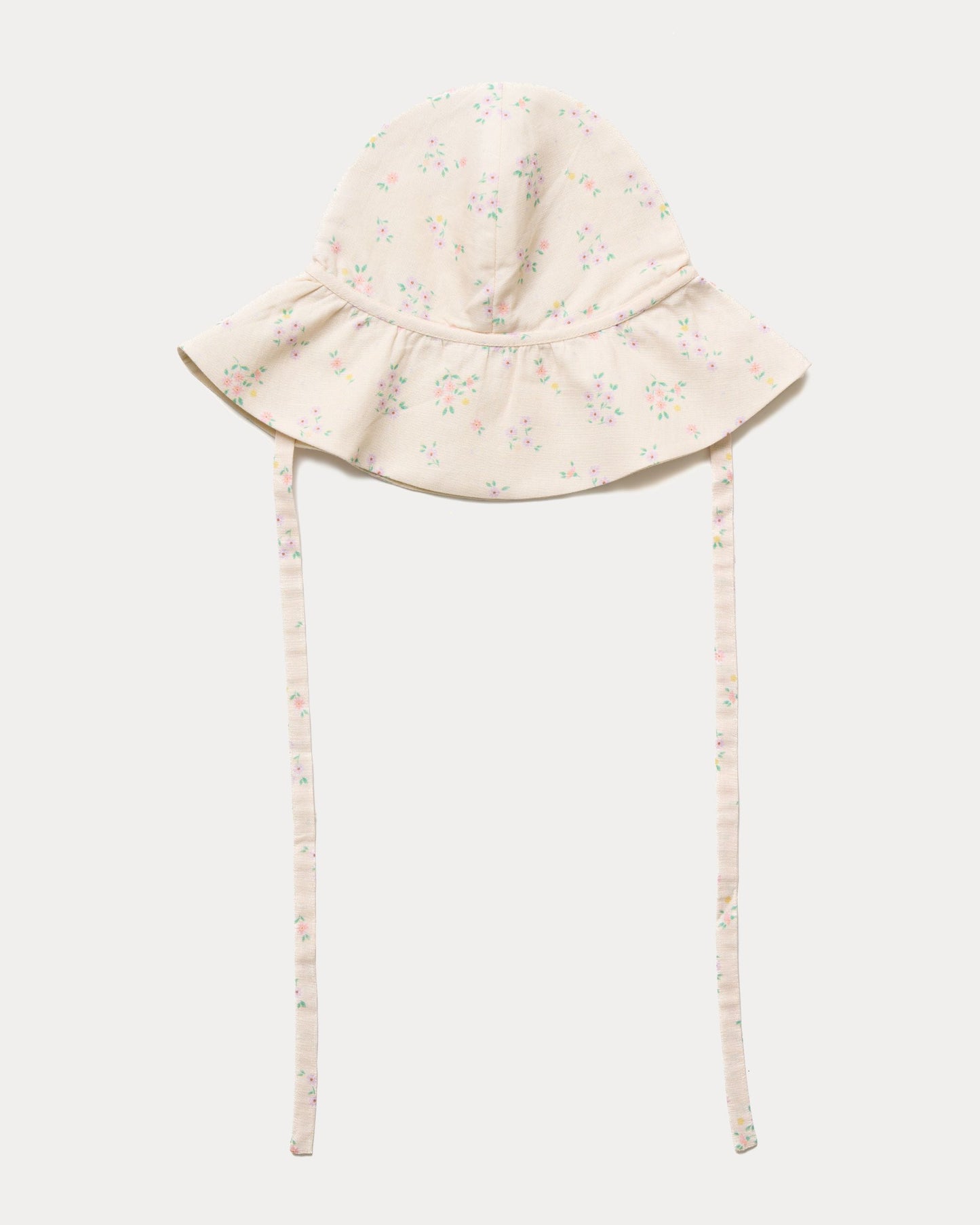 Early Sunday, Bonnie Hat Cap in Painted Bouquet print, made from 70% Cotton, 30% Linen fabric, shown in a front flat-lay view with wide brim and tie straps