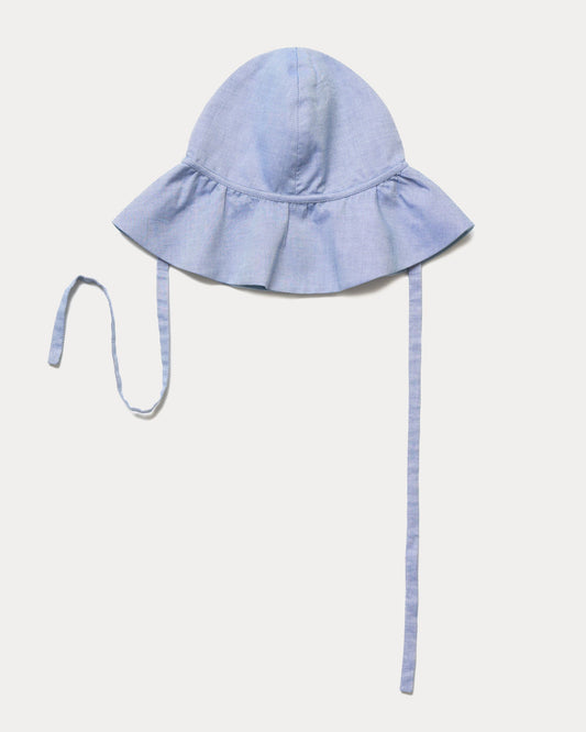 Early Sunday, Bonnie Hat Cap in Summer Sky color, made from Chambray fabric, shown in an angled view with wide brim and tie straps