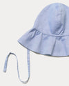 Early Sunday, Bonnie Hat Cap in Summer Sky color, made from Chambray fabric, shown in a closeup flat-lay view