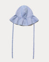 Early Sunday, Bonnie Hat Cap in Summer Sky color, made from Chambray fabric, shown in a front flat-lay view with wide brim and tie straps