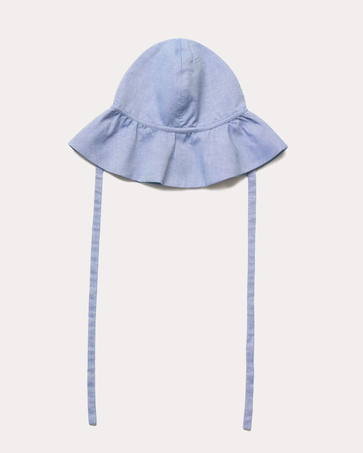 Early Sunday, Bonnie Hat Cap in Summer Sky color, made from Chambray fabric, shown in a front flat-lay view with wide brim and tie straps