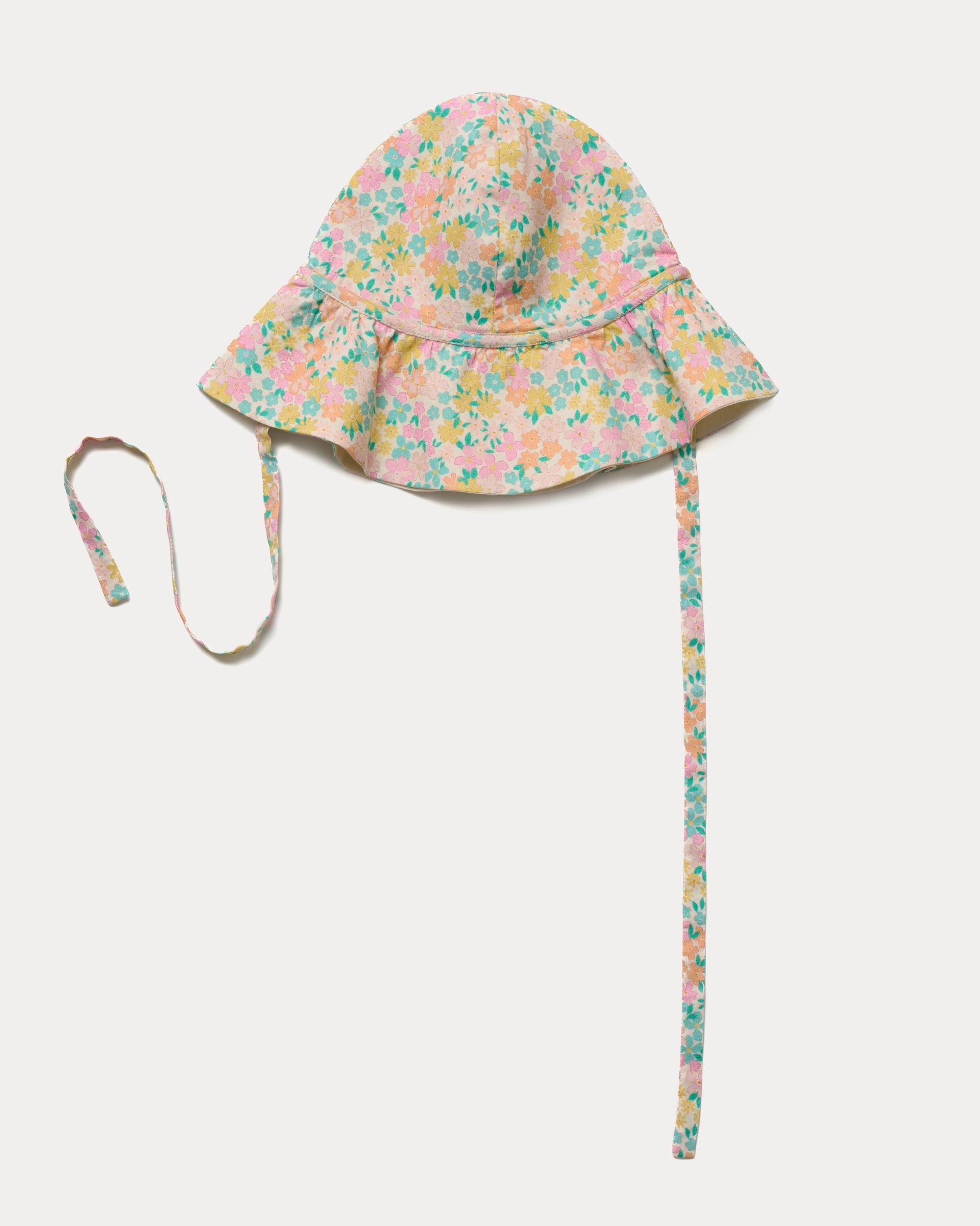 Early Sunday, Bonnie Hat Cap in Emma Floral Mint color, made from Organic Printed Cotton Cambric fabric, shown in an angled view with wide brim and tie straps