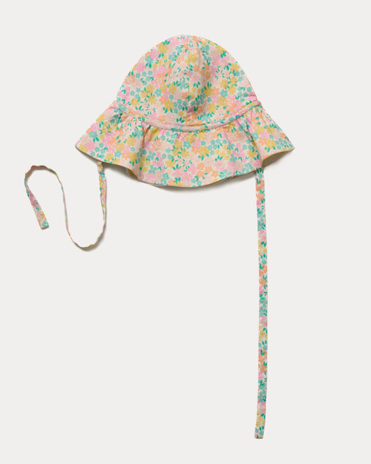Early Sunday, Bonnie Hat Cap in Emma Floral Mint color, made from Organic Printed Cotton Cambric fabric, shown in an angled view with wide brim and tie straps