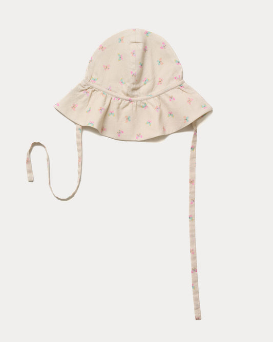 Early Sunday, Bonnie Hat Cap in Butterflies print, made from Printed Tiny Swiss Dobby fabric, shown in an angled view with wide brim and tie straps